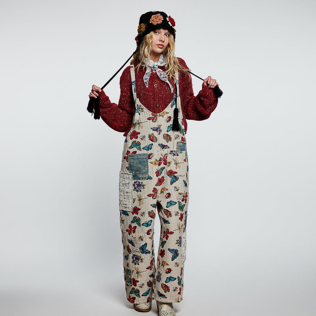 POL almond butterfly print overalls on model, front view showing bib neckline and black tassel shoulder straps
