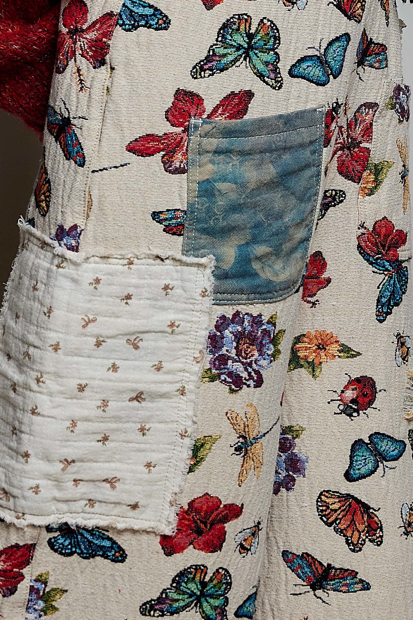 POL almond butterfly print overalls close-up detail of mixed denim pocket, quilted patchwork panel, and floral print
