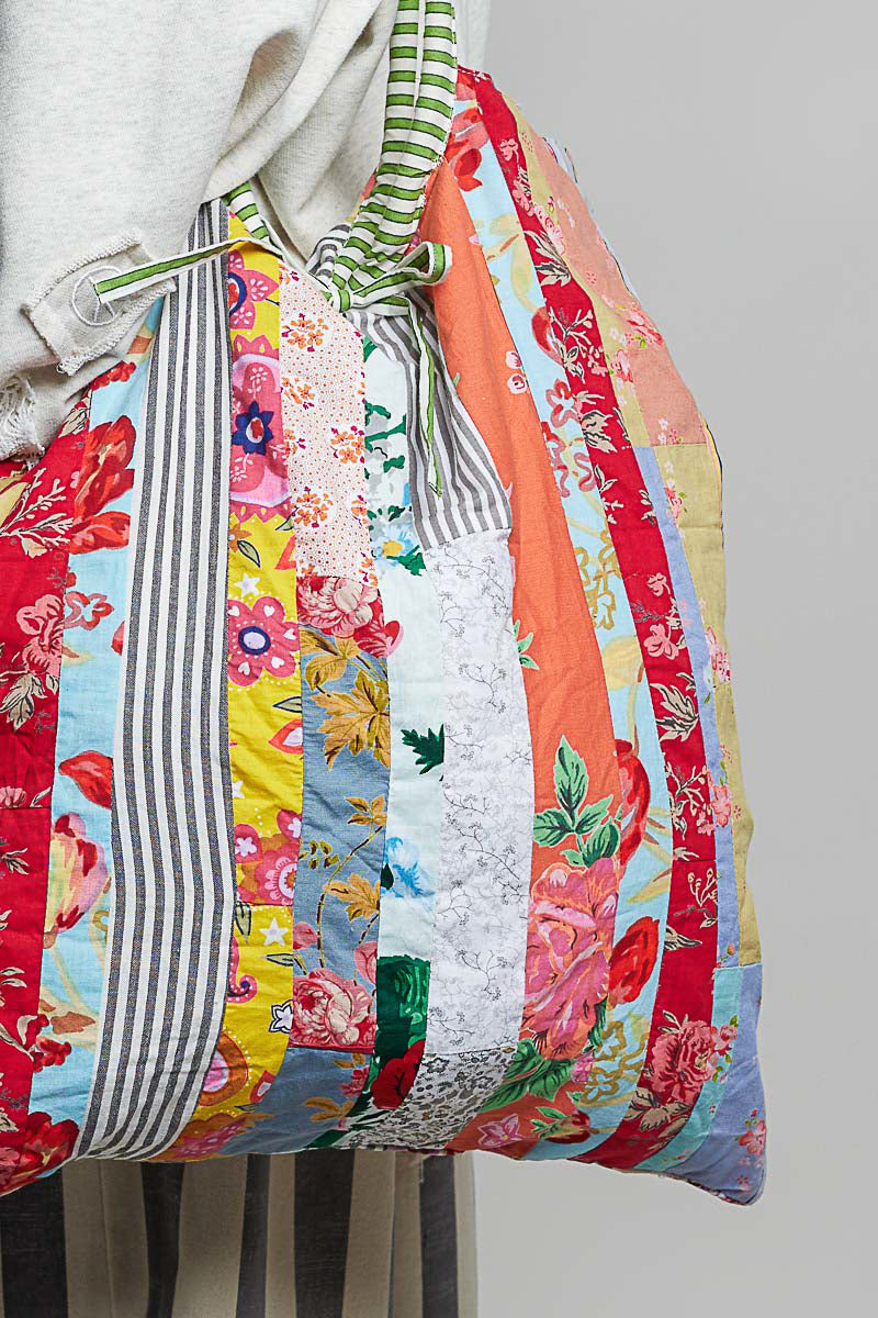 POL Clothing cream multi quilted patchwork tote bag on model over shoulder
