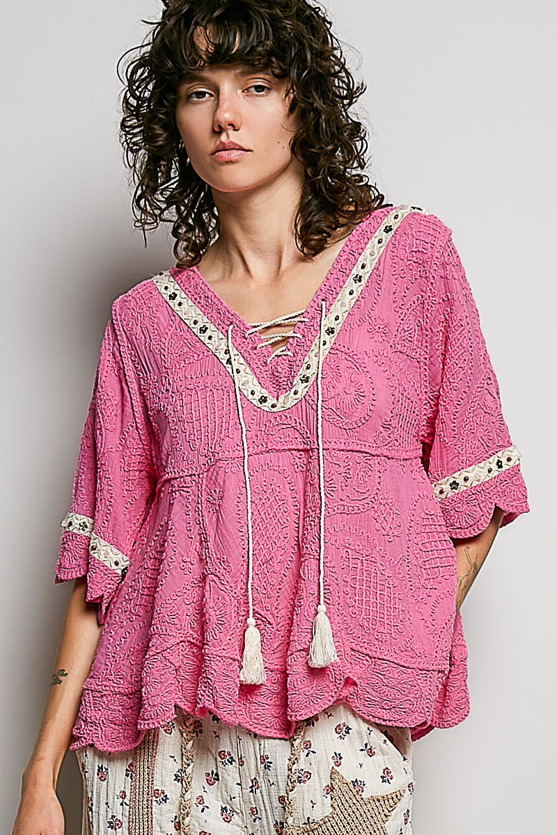 POL women's pink crochet tassel blouse on model, front view with flared sleeves and scalloped hem
