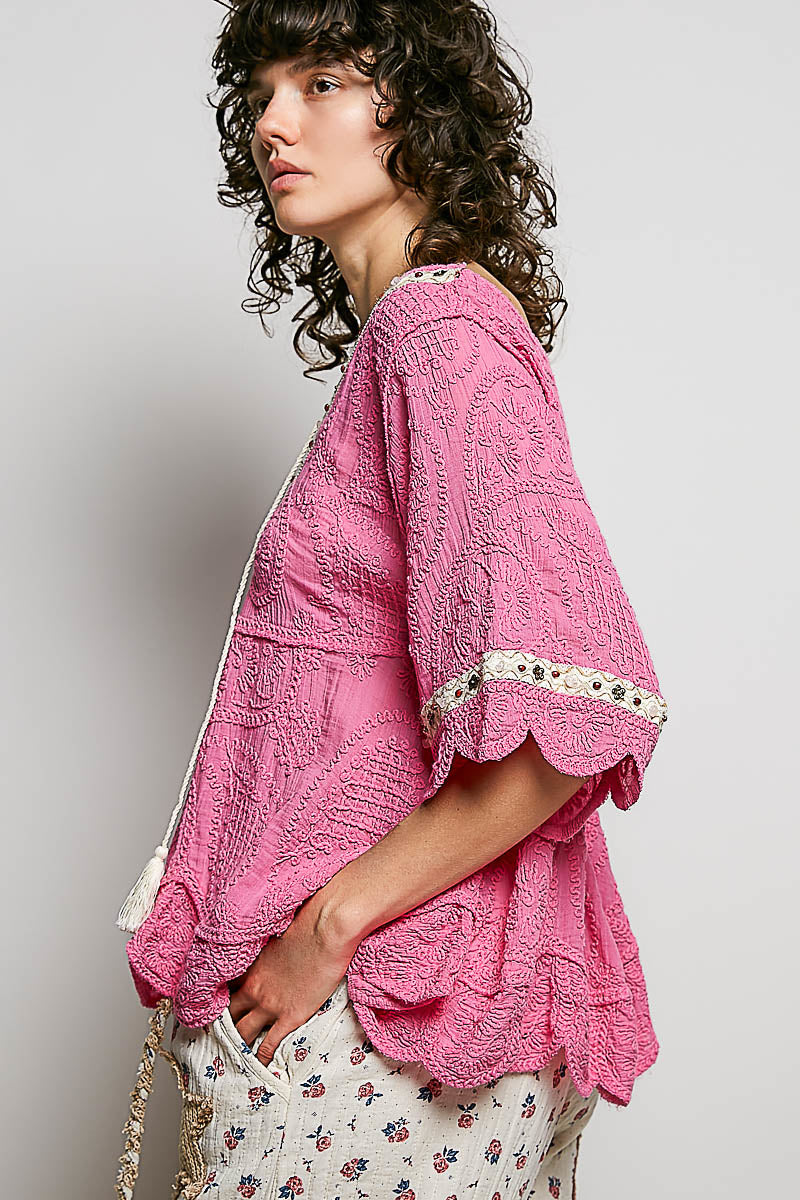 POL women's pink crochet lace-up blouse on model, three-quarter front view showing contrast trim

