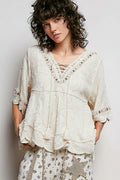 POL women's off white crochet tassel blouse on model, three-quarter angle showing sleeve drape
