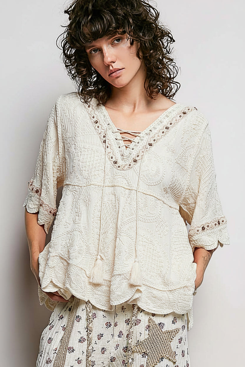 POL women's off white crochet tassel blouse on model, three-quarter angle showing sleeve drape
