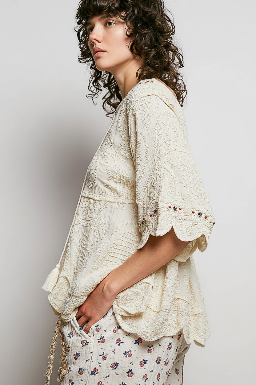 POL women's off white crochet blouse on model, side view showing scalloped hem and flared sleeve
