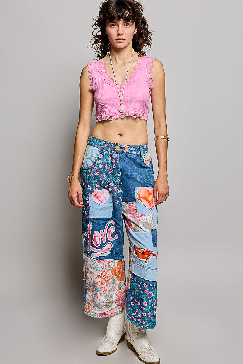 POL Clothing women's POL Patchwork Wide-Leg Denim Pants - Denim Multi with floral patches and Love embroidery on sidewalk