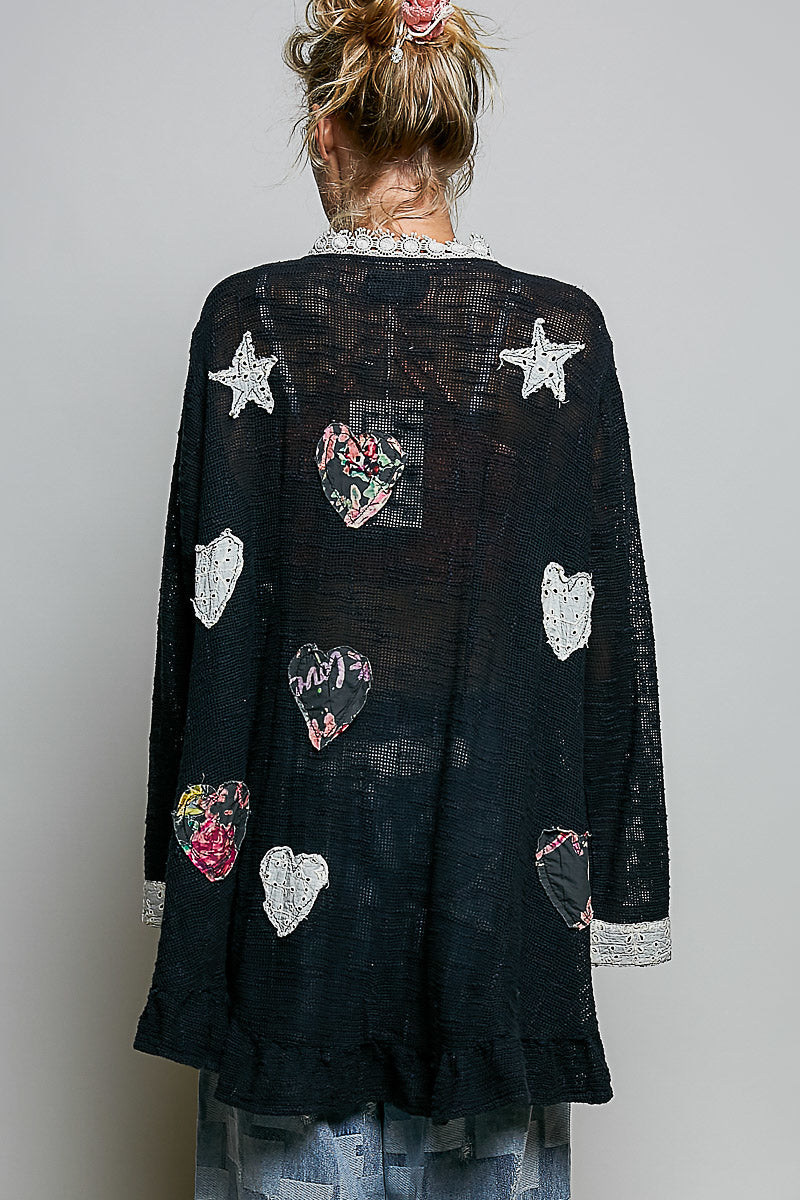 POL black heart star appliqué cardigan with lace cuffs, side angle full-length view on model
