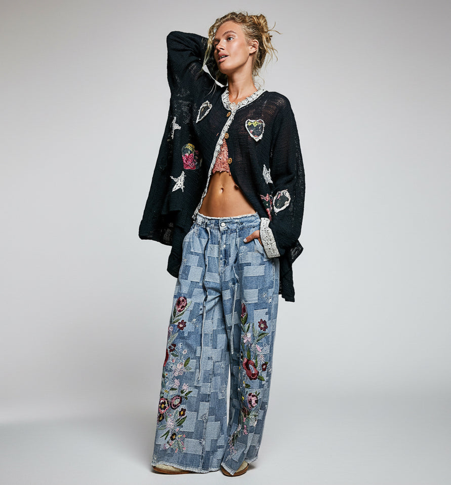 POL Clothing black open-knit cardigan with heart and star appliqués, full-length side view on model
