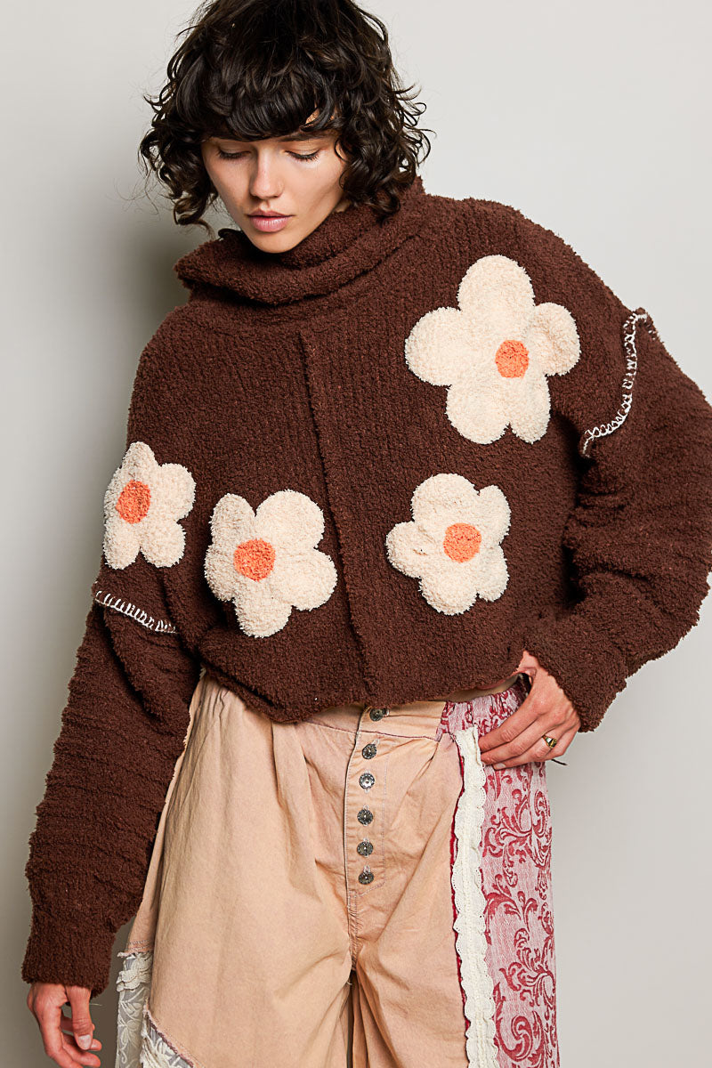 POL Clothing brown boucle turtleneck sweater with daisy appliqués, full-length on model
