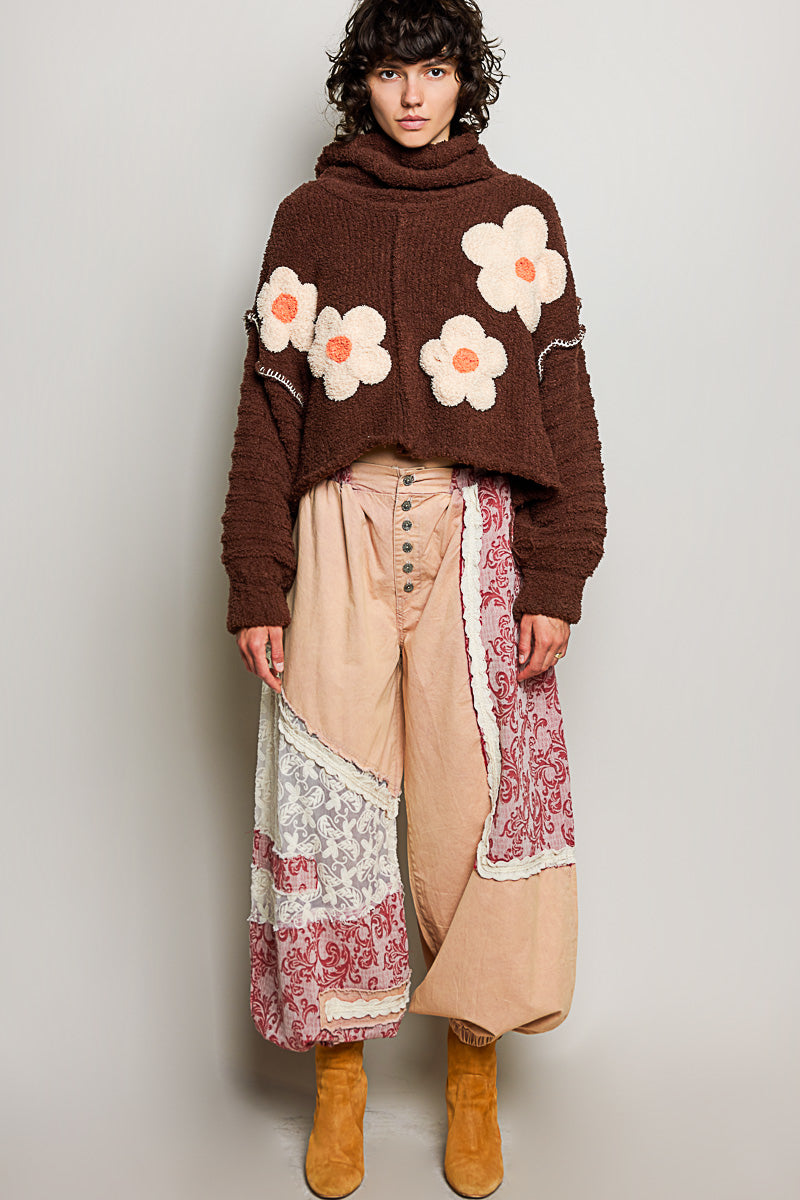POL Clothing brown boucle daisy appliqué turtleneck sweater, side view on model
