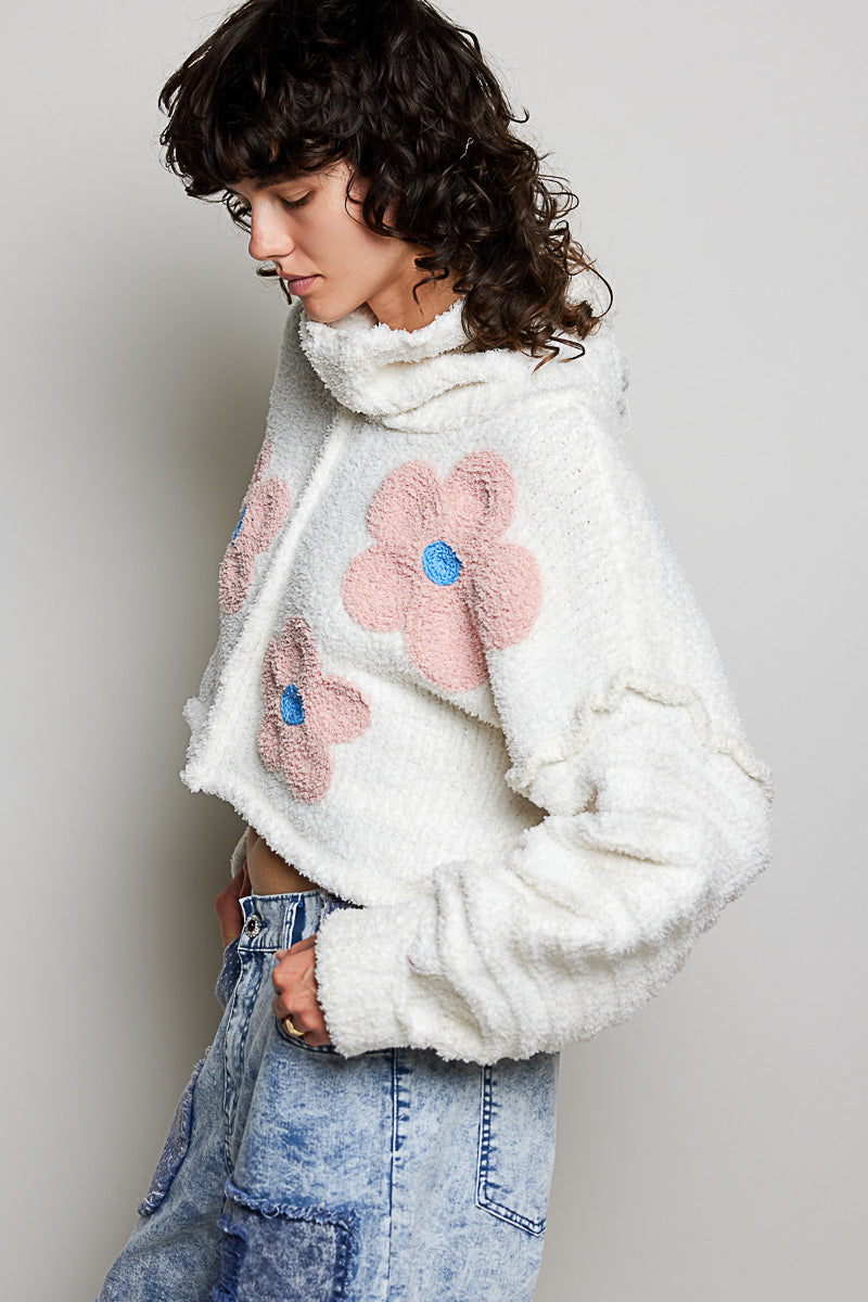 POL Clothing ivory boucle turtleneck sweater with pink daisy appliqués, back view on model
