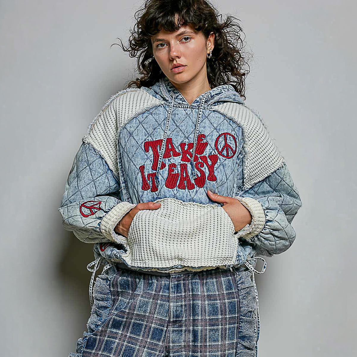 POL Clothing Denim Multi quilted hoodie on model, front view showing Take It Easy embroidery and waffle-knit front pocket
