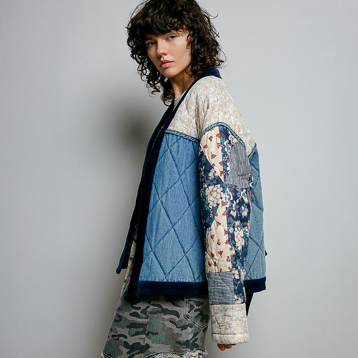 POL Clothing Denim Multi quilted patchwork cardigan back view, floral and stripe patchwork sleeves on model
