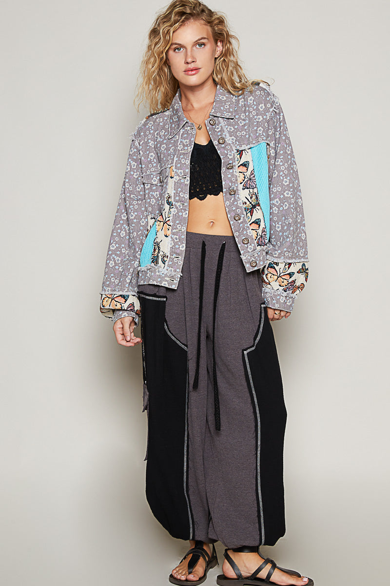 POL women's floral patchwork cropped denim jacket, back view showing butterfly tapestry yoke and turquoise ribbed knit insert - BellanBlue
