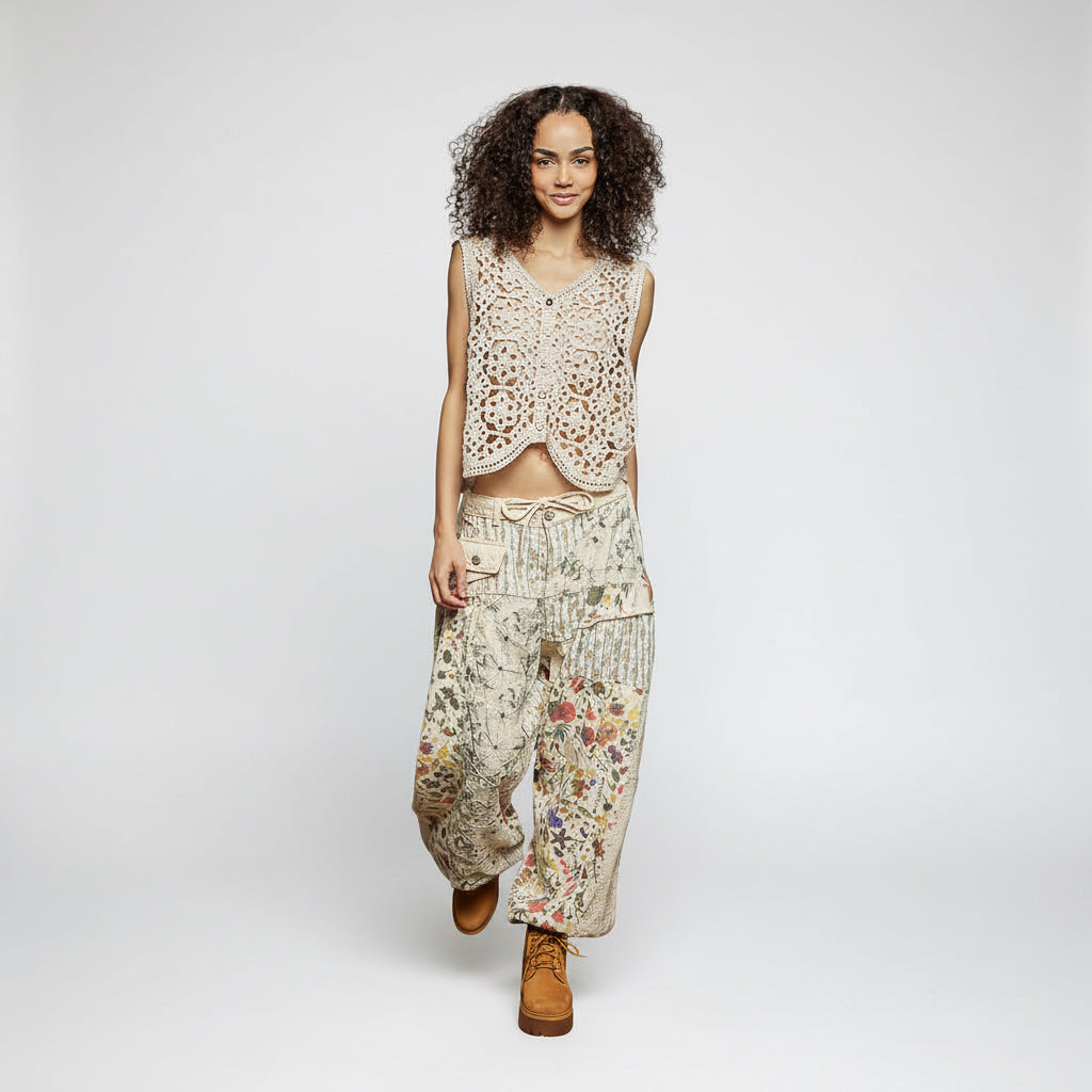 Woman wearing a patterned outfit with a textured wall background