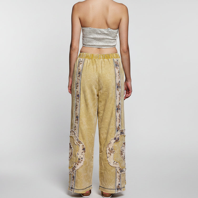 POL Clothing lemon patchwork wide-leg pants on model, back view showing elastic waistband and floral panels
