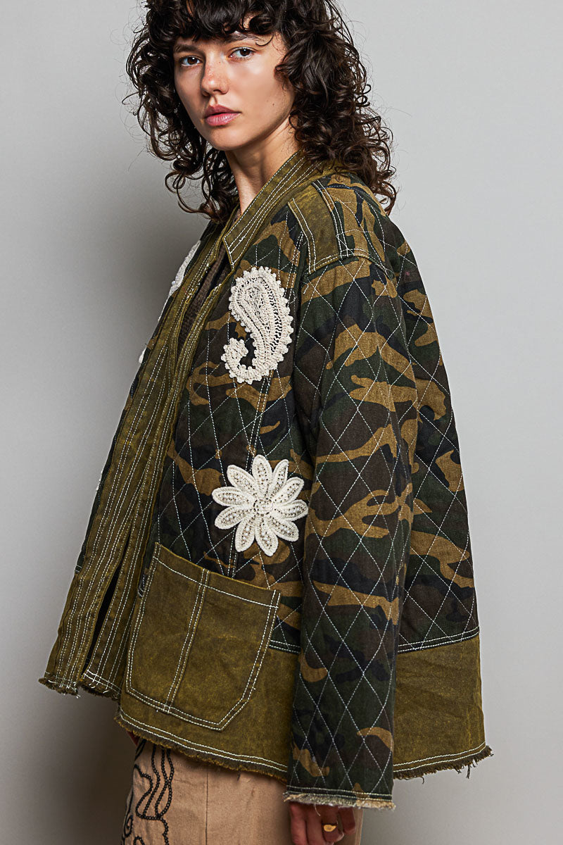POL Clothing olive camo quilted open-front jacket, three-quarter view showing lace floral patch detail on model
