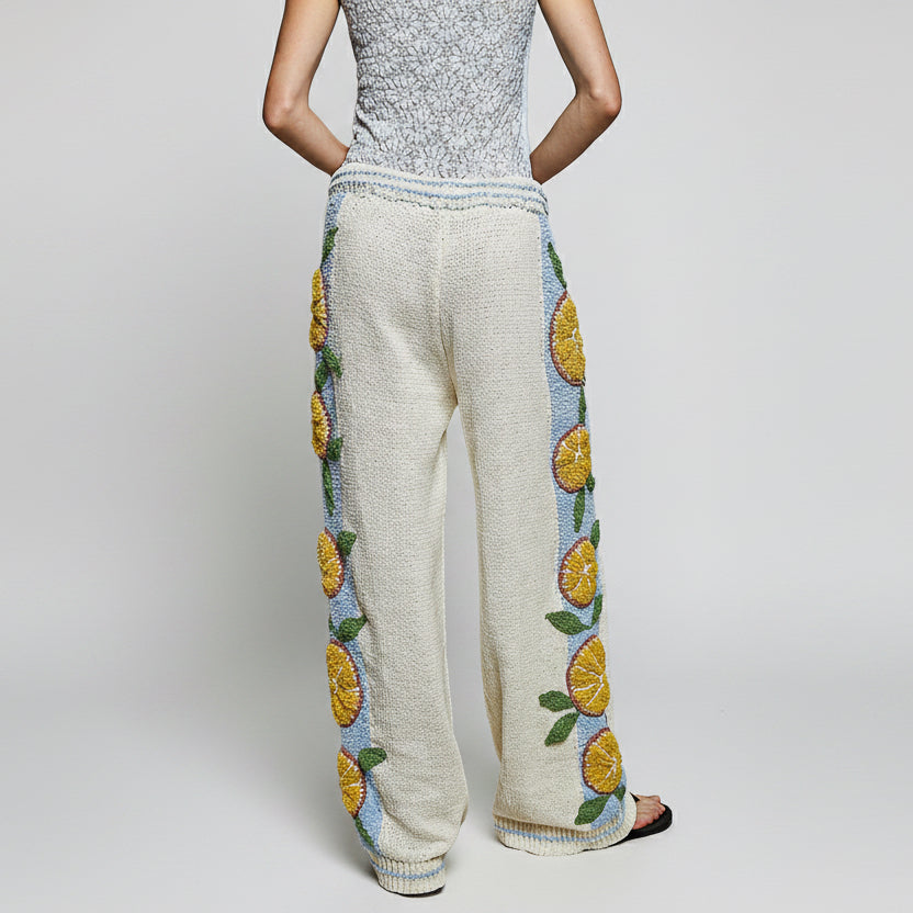 Back view of POL Clothing cream embroidered wide leg knit pants with ribbed elastic waistband