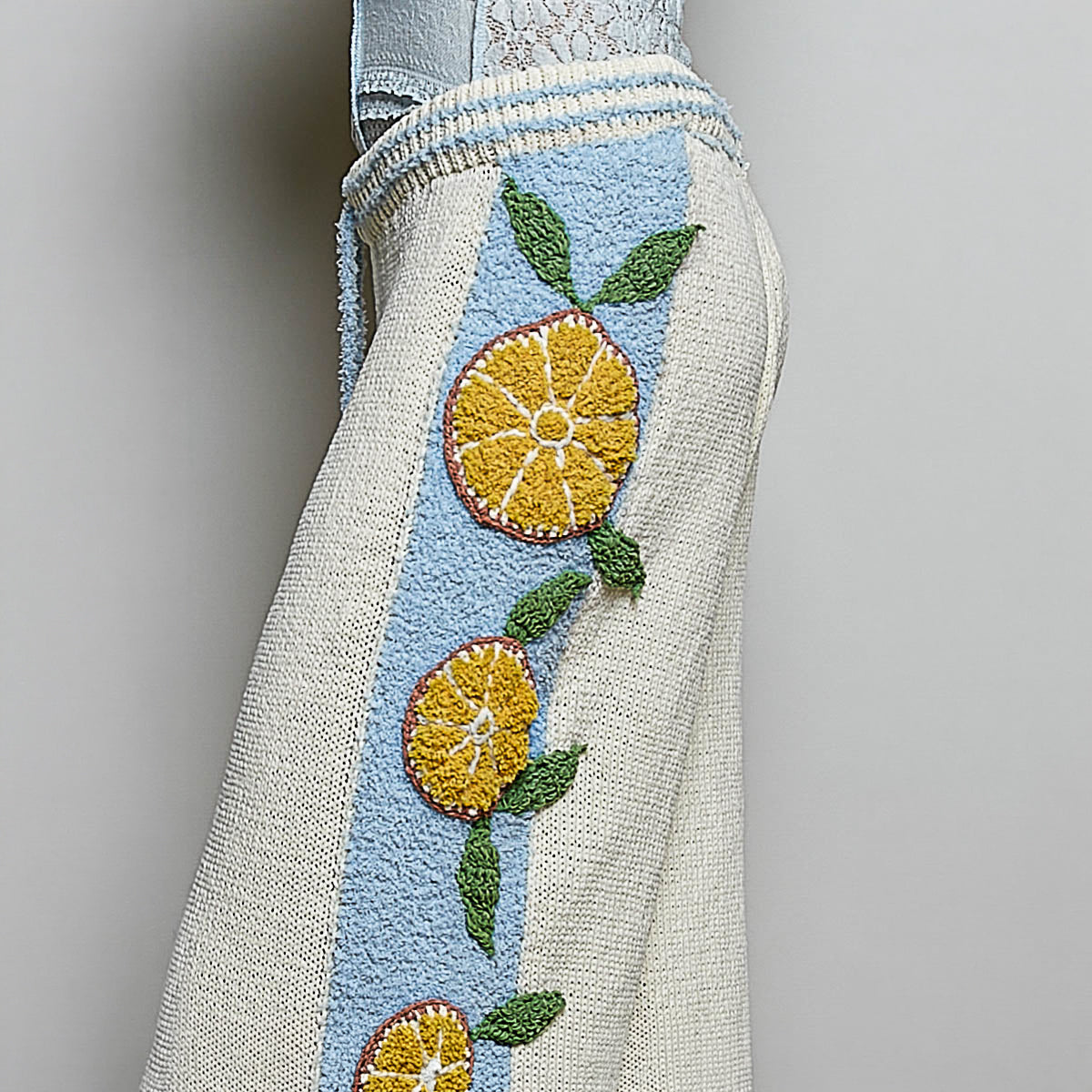 POL Clothing cream wide leg knit pants featuring ribbed drawstring waist and citrus motif details