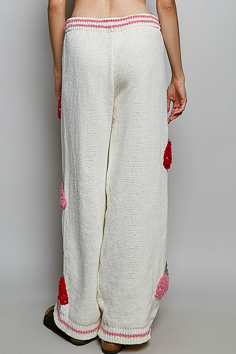 POL Clothing cream chenille wide-leg pants, back view on model showing strawberry patches and pink crochet hem trim
