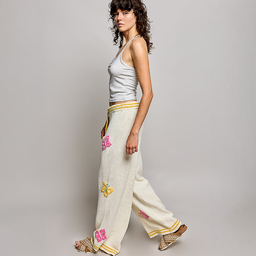 POL Clothing women's cream multi crochet butterfly wide leg knit pants, full-length front view on model - BellanBlue
