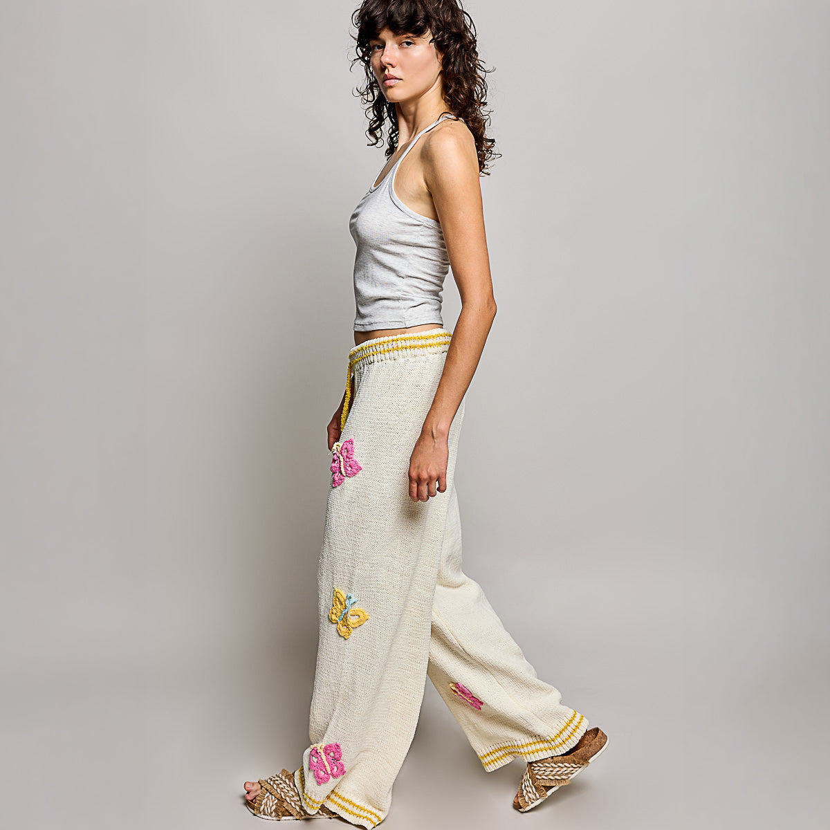 POL Clothing women's cream multi crochet butterfly wide leg knit pants, full-length front view on model - BellanBlue
