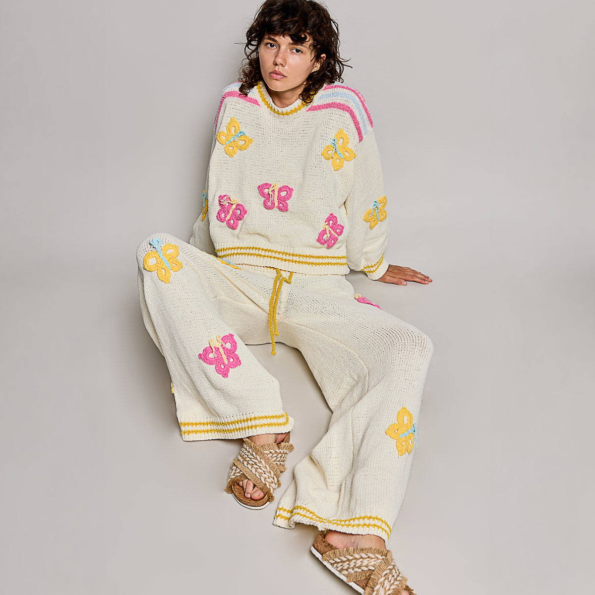 POL Clothing cream multi butterfly chenille sweater top and wide-leg pants matching set on model, seated angle
