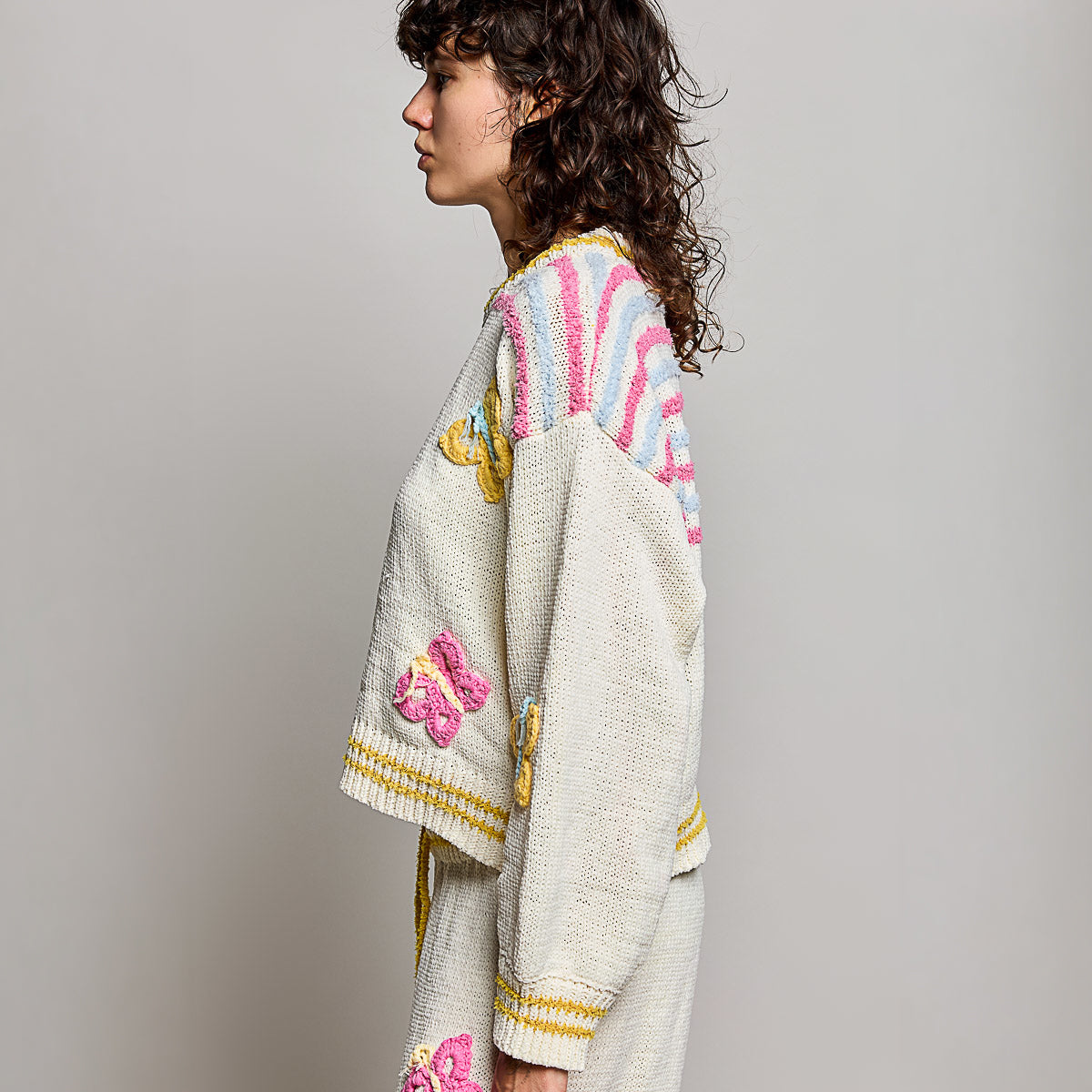 POL Clothing cream multi butterfly chenille sweater top on model, side view showing balloon sleeve and stripe yoke detail
