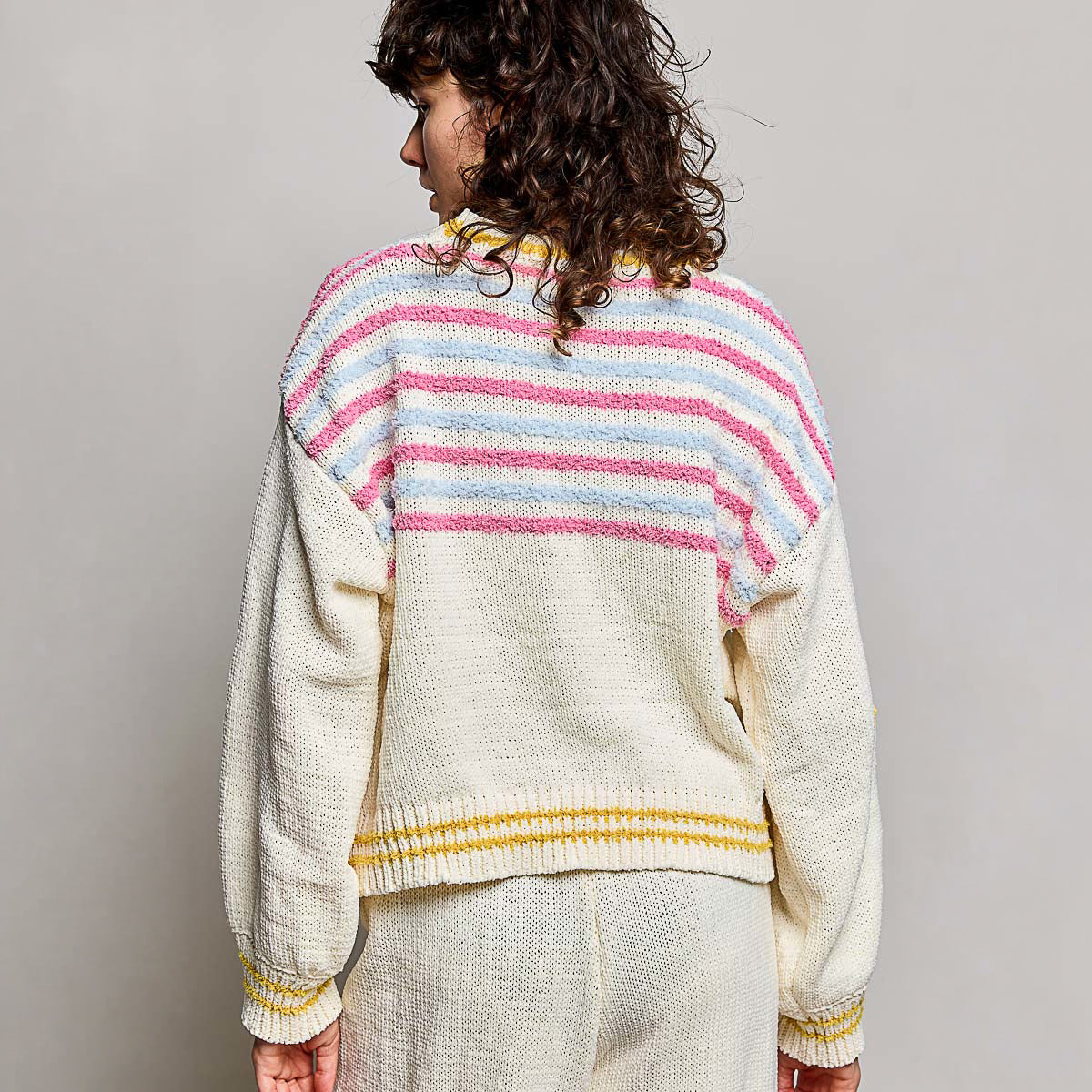 POL Clothing cream multi chenille sweater top on model, back view showing pink and blue stripe yoke and mustard ribbed hem
