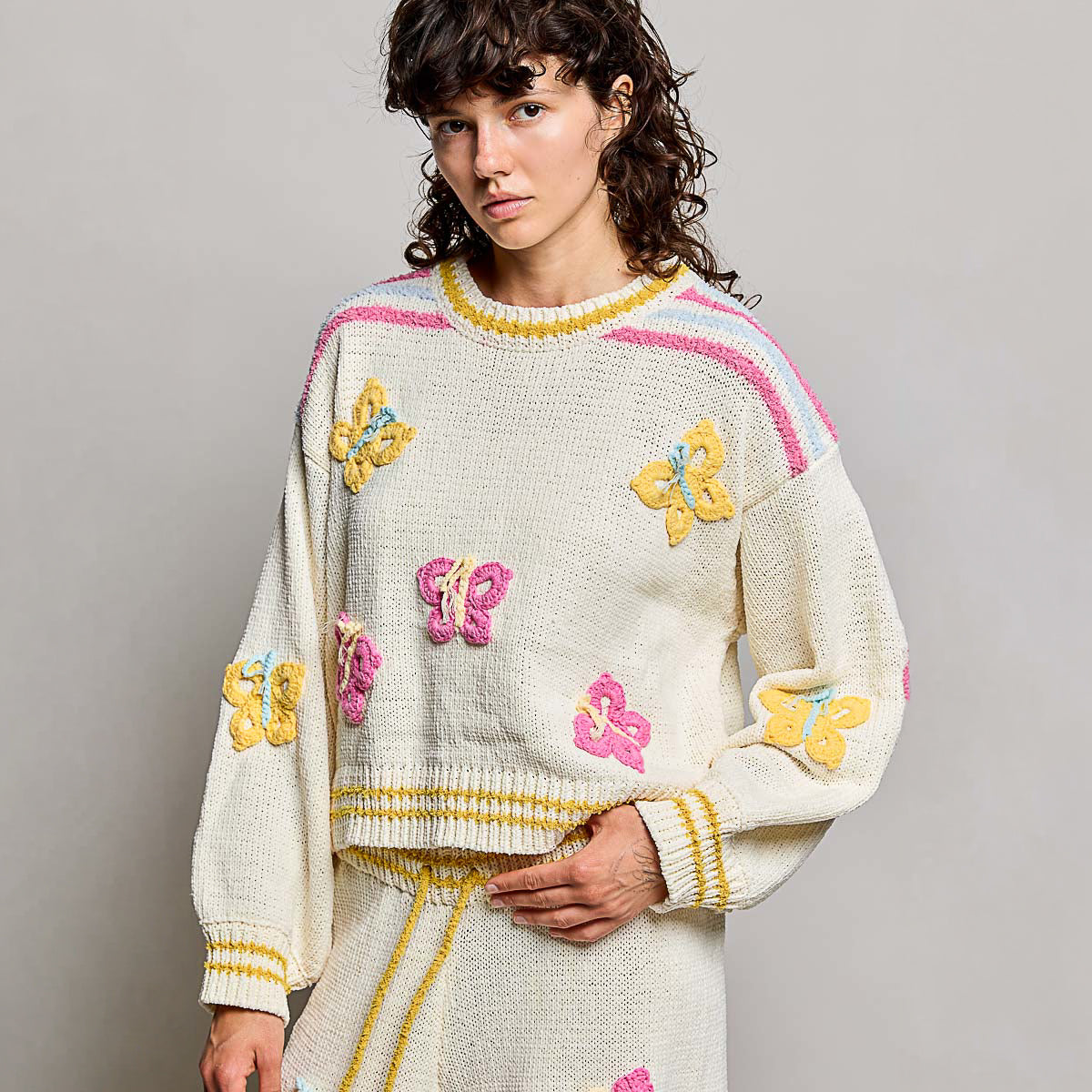 POL Clothing cream multi 3D butterfly chenille sweater top on model, front close-up showing round neckline and crochet appliqués
