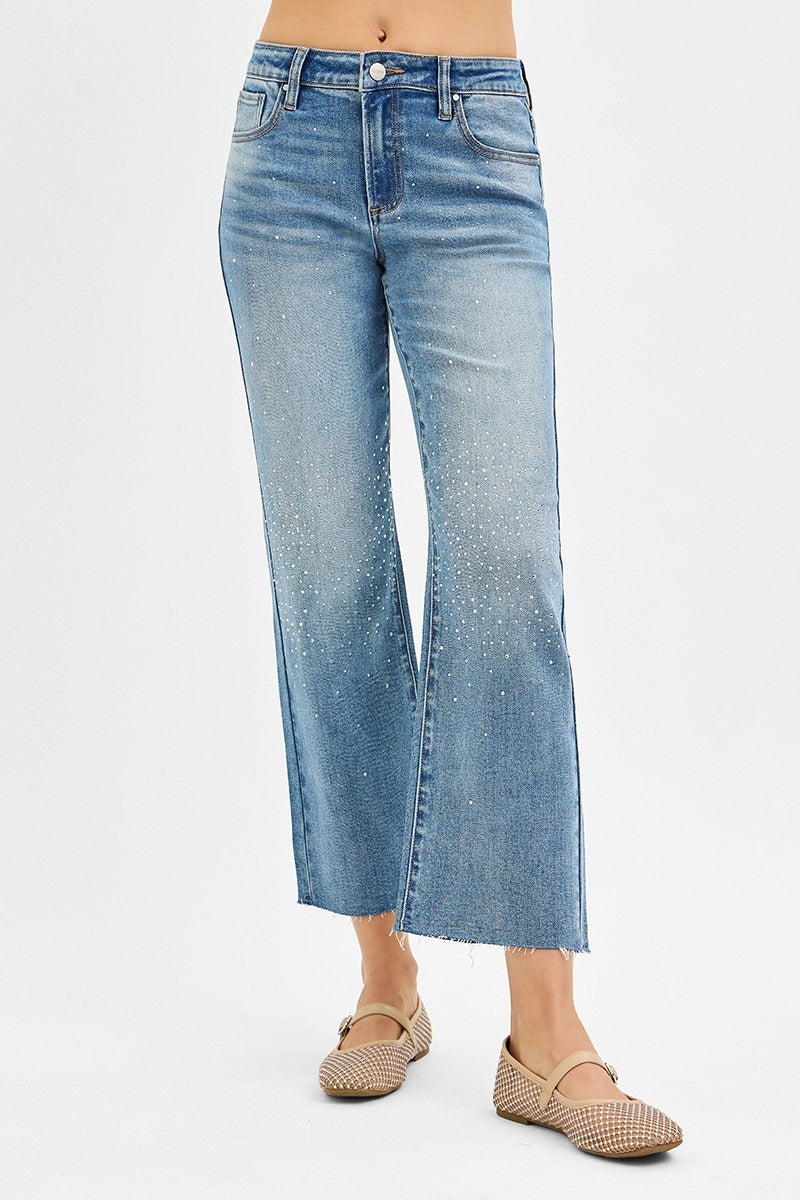Blue jeans worn by a person on a white background