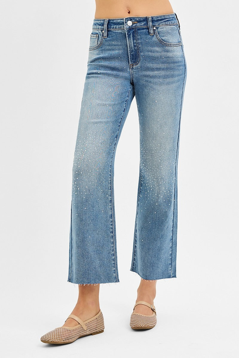 Blue jeans worn by a person on a white background