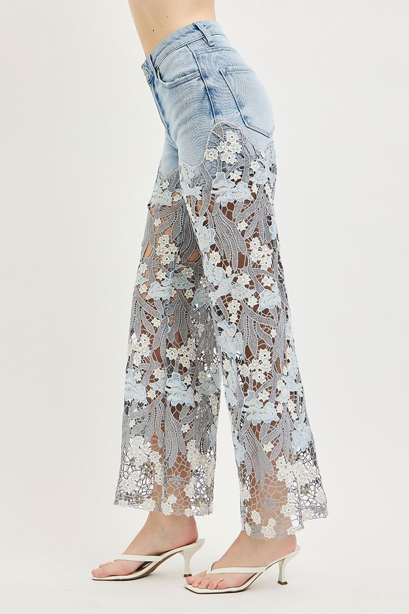 Light blue jeans with floral lace overlay on a white background