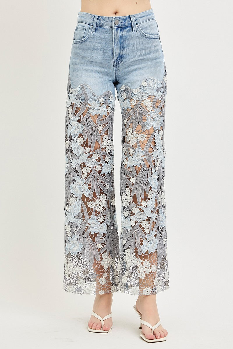 Light blue jeans with floral lace overlay on a white background