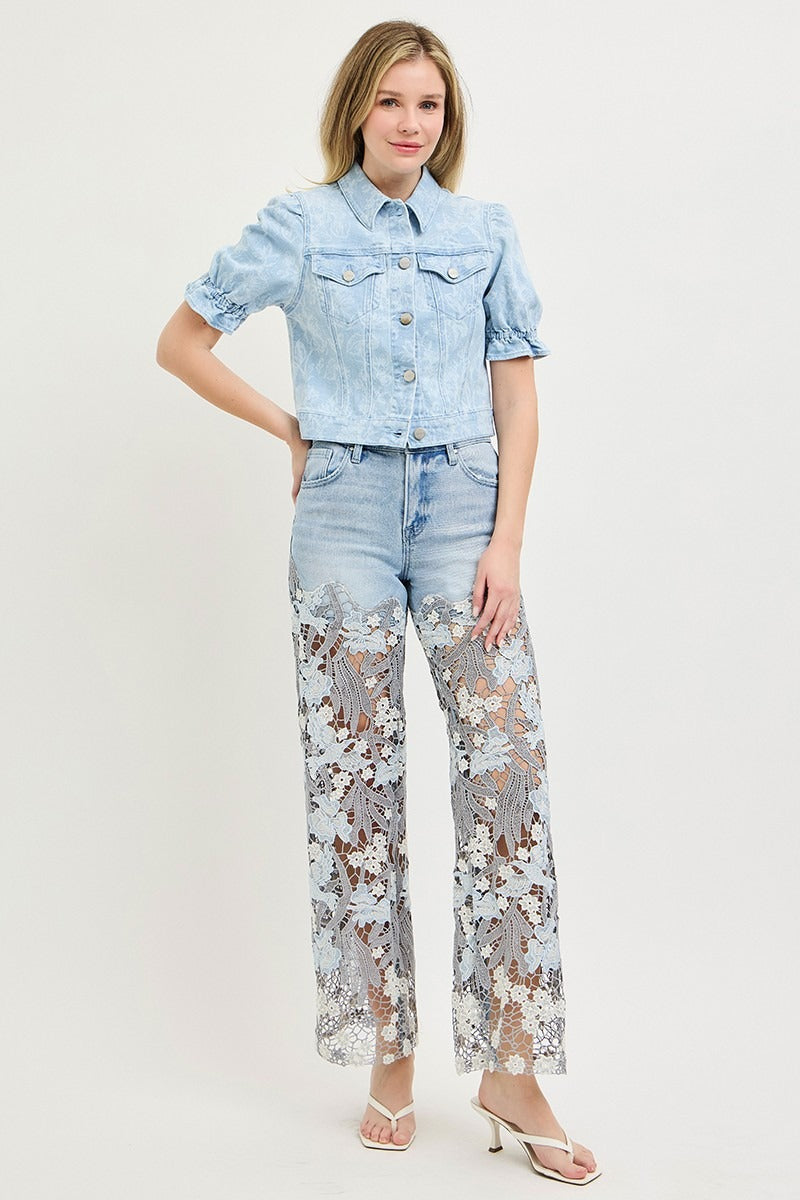 Woman wearing a light blue denim outfit with floral pants on a white background