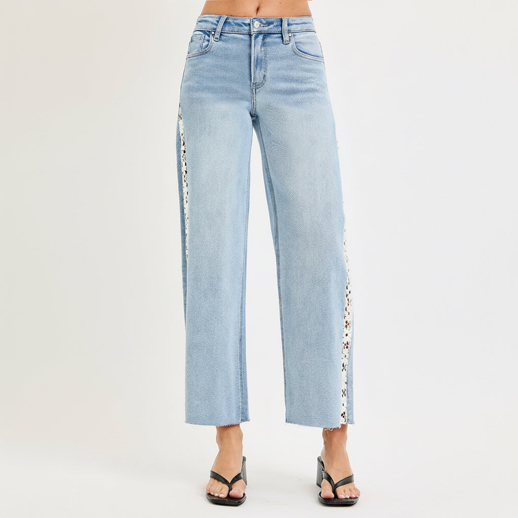 Side view of Risen light wash wide leg crop jeans showing full white floral lace panel and back pocket