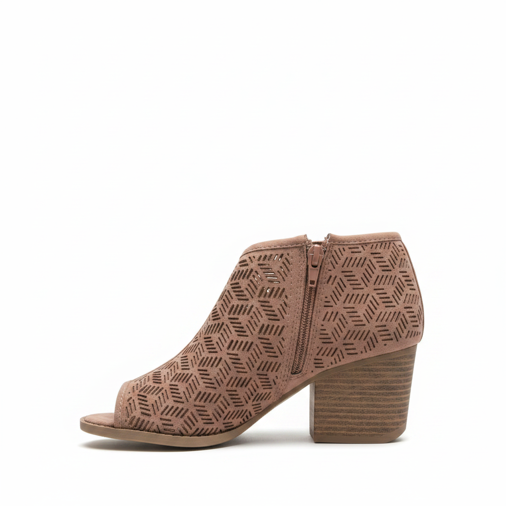 Women's dusty blush laser cut peep toe ankle bootie side profile view showing geometric suede upper and stacked block heel