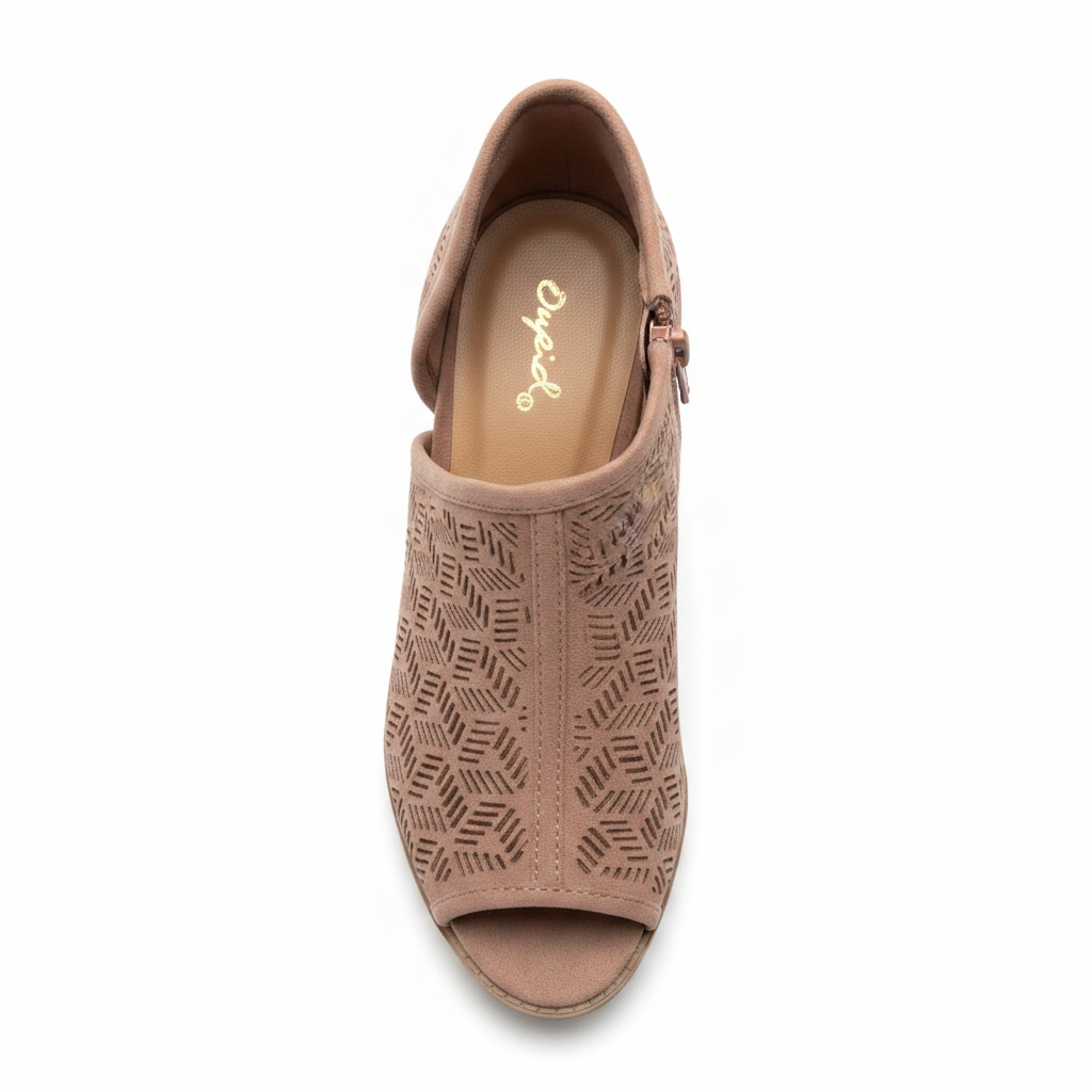 Overhead top view of women's dusty blush peep toe ankle bootie showing geometric laser cut pattern and open toe opening