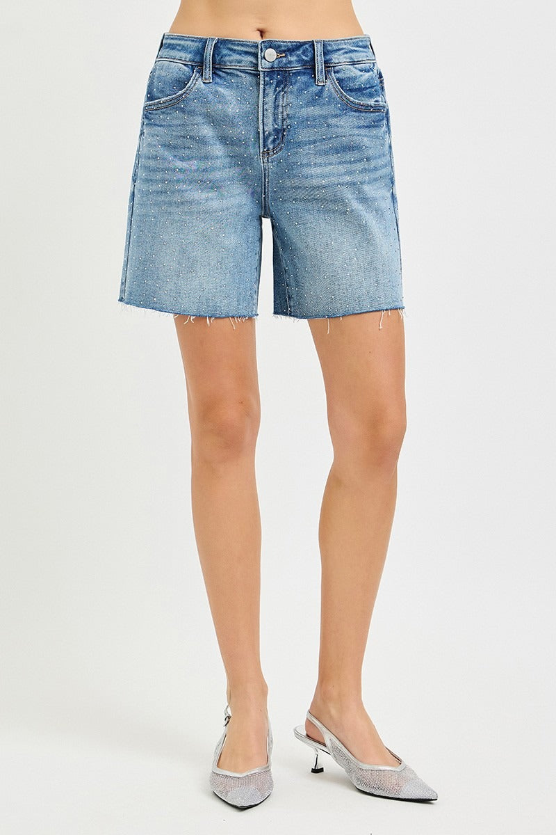 Denim shorts worn by a person on a white background