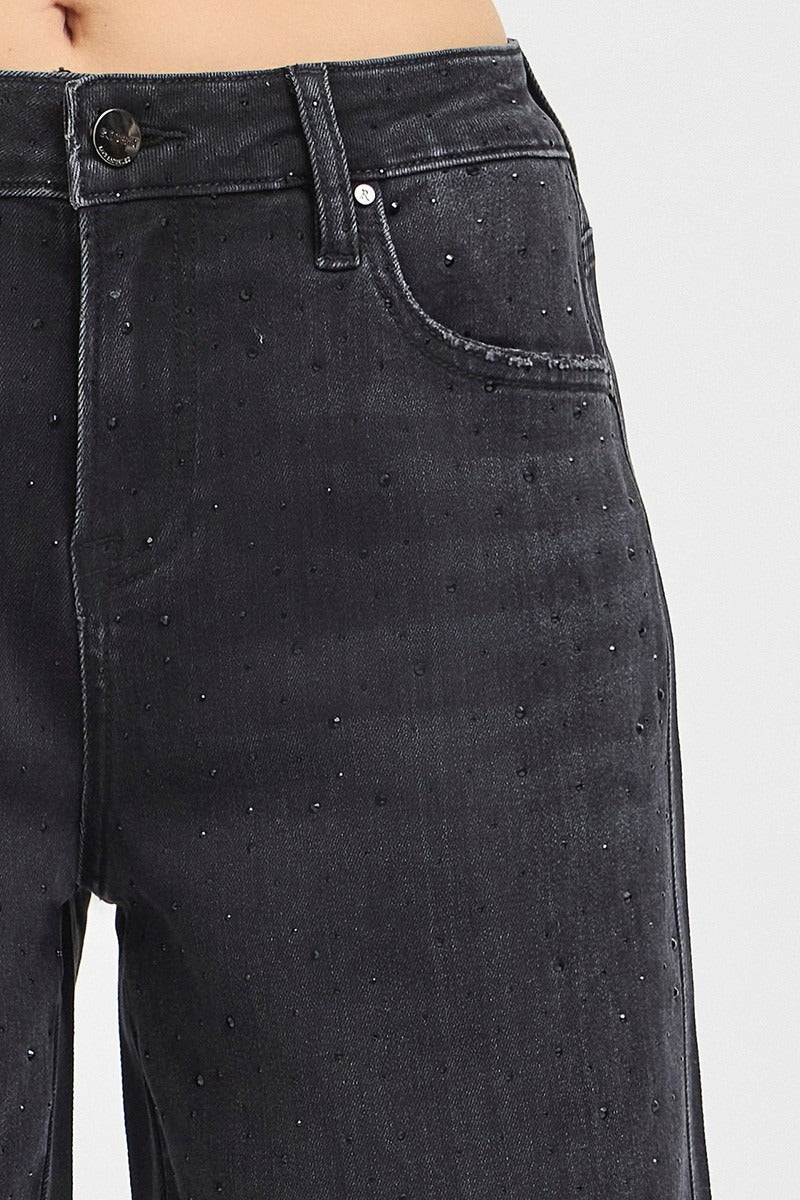 Black distressed jeans on a white background