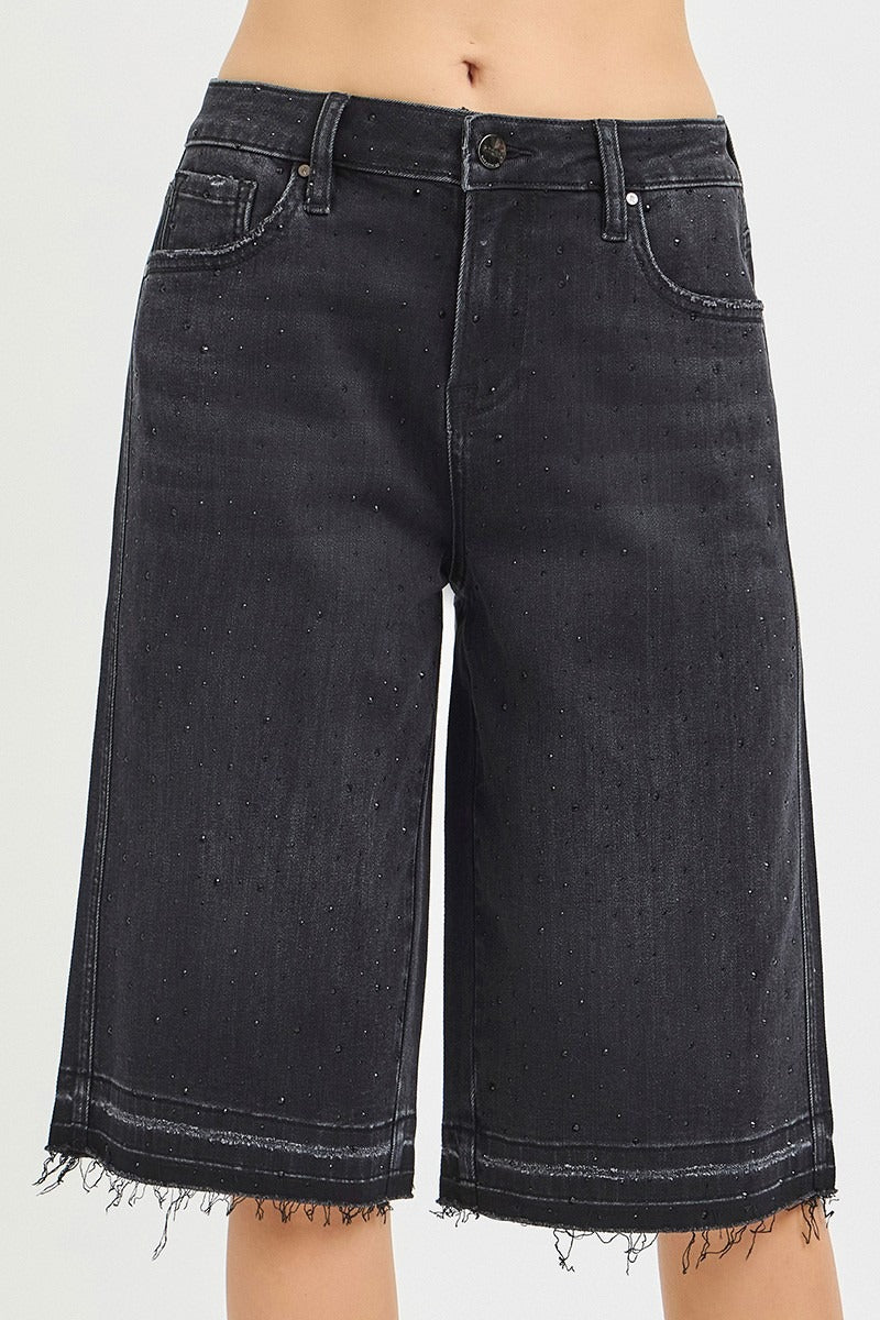 Black denim shorts on a white background