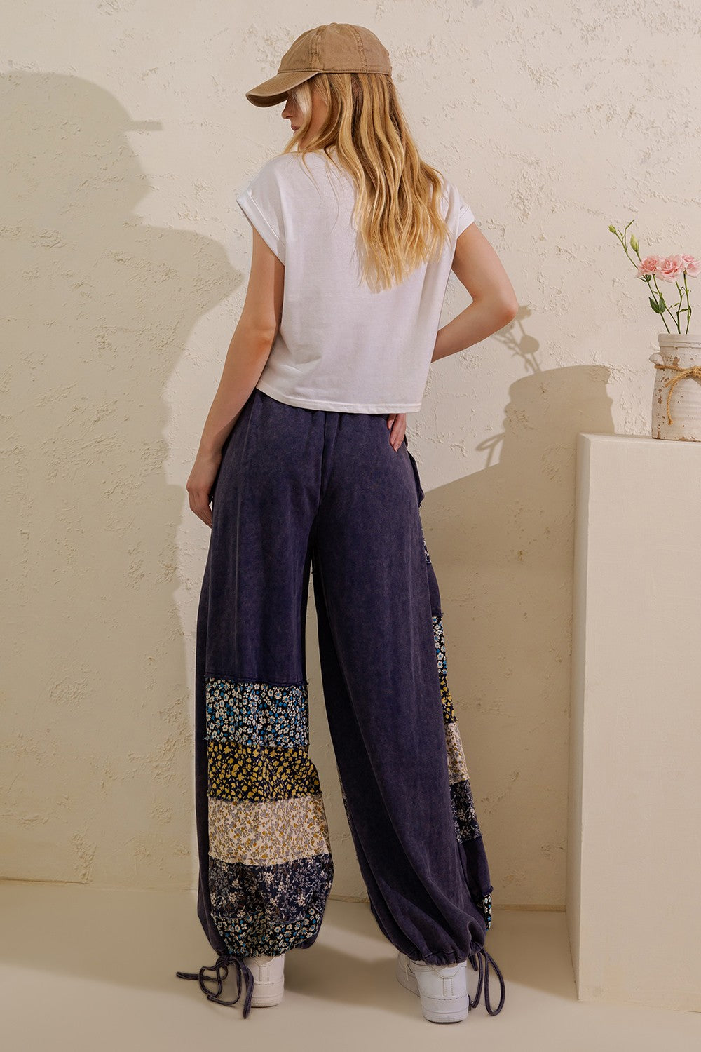 Sage + Fig navy floral panel pants close-up showing front utility flap pockets