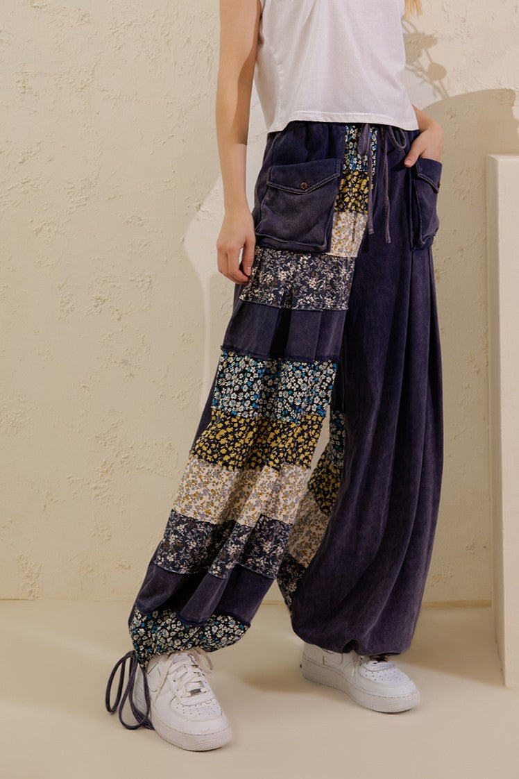 Sage + Fig navy drawstring wide-leg pants showing floral print panels and adjustable hems