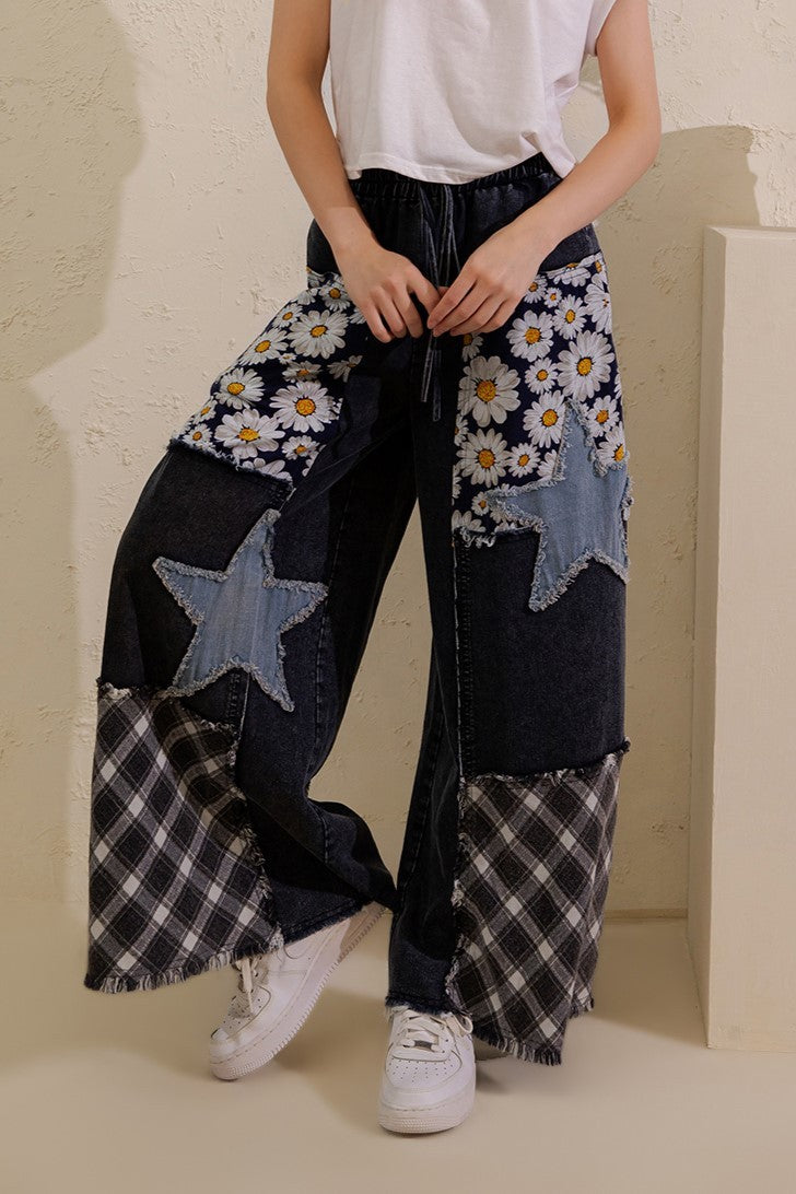 Sage + Fig women's denim patchwork wide-leg pants styled with a white tee, side view