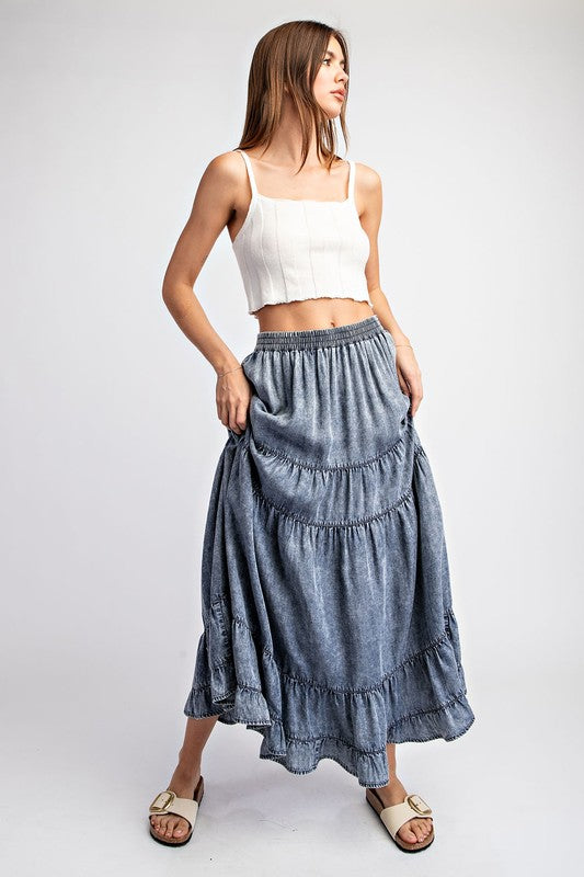 a woman in a white top and blue skirt