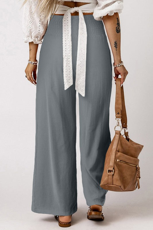 a woman wearing a white shirt and gray pants