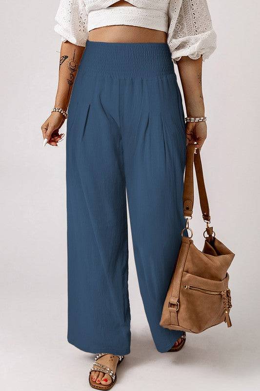 a woman wearing a white top and blue pants