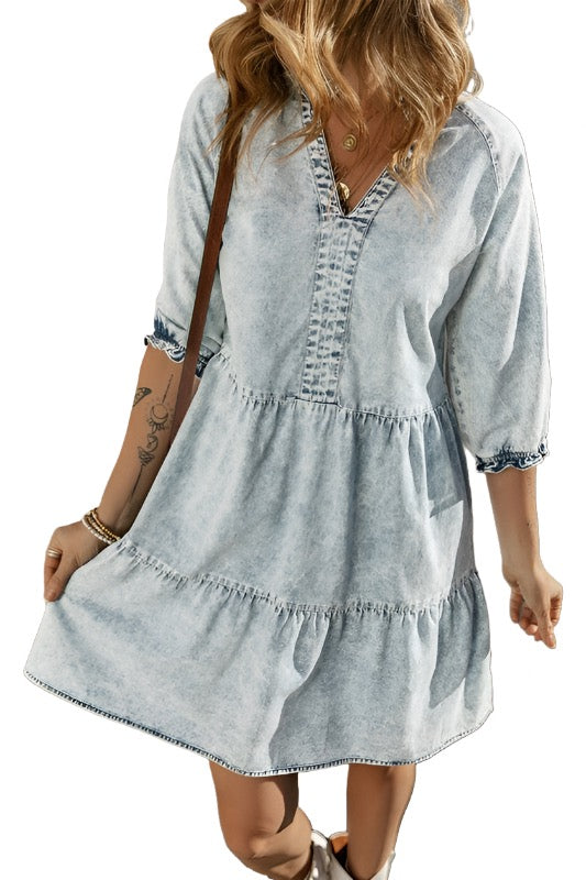 a woman wearing a denim dress and a hat