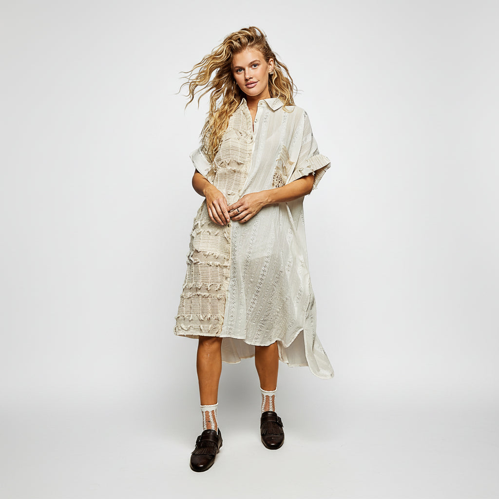 Woman wearing a light-colored dress with a white background