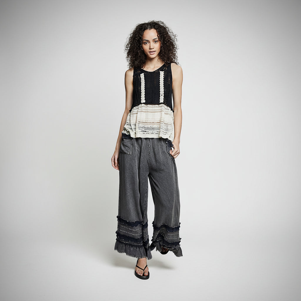 Women's charcoal washed wide-leg ruffle hem pants, fluid drape silhouette, full body front view
