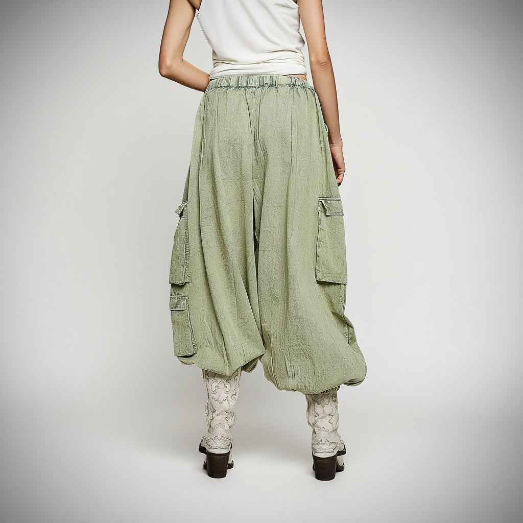 Women's olive multi patchwork drawstring pants, back or detail view showing patchwork print and straight-leg hem
